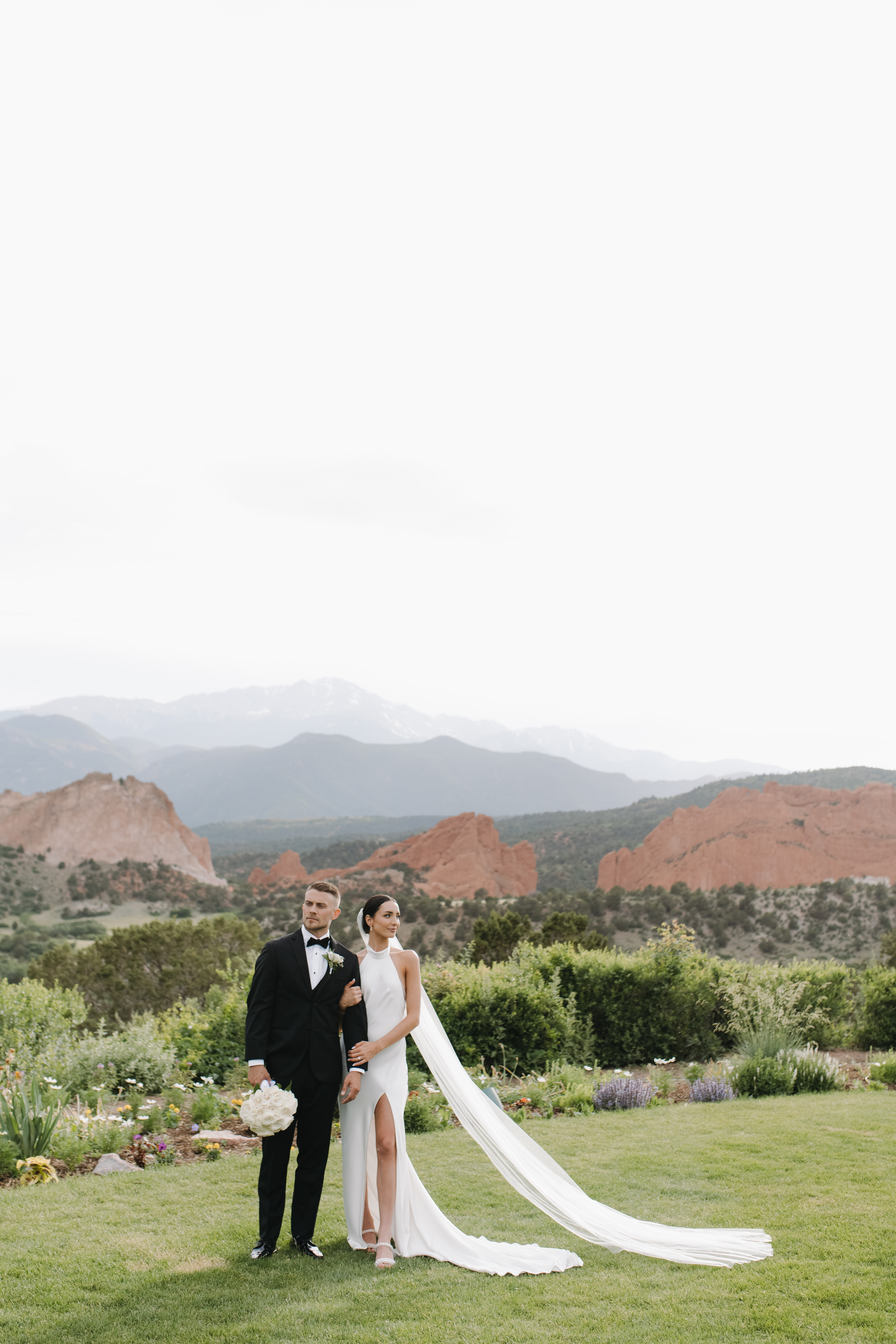 Bride and groom at The Garden of the Gods Resort and Spa with Pikes Peak in the backgroun